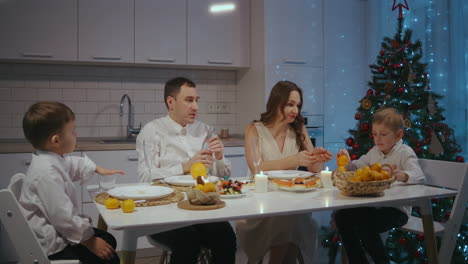 Family-Christmas-dinner-the-father-opens-the-champagne-cheers-and-joyful-congratulations.-Celebrate-the-new-year.-High-quality-4k-footage
